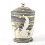 A marbled Jasperware jar and cover, by Wedgwood.