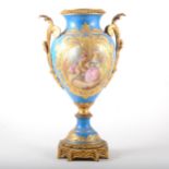 A Sevres style blue celeste porcelain and gilt metal ornamental urn
