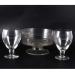 A large George III rummer, three other large rummers, and a pedestal glass bowl.