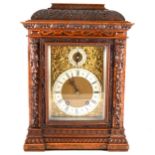A late Victorian figured and carved walnut mantel clock, ...