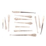 A collection of Victorian and later button hooks with embossed silver shafts, plus a Victorian