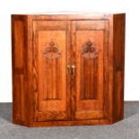 A reproduction oak corner cabinet, ...