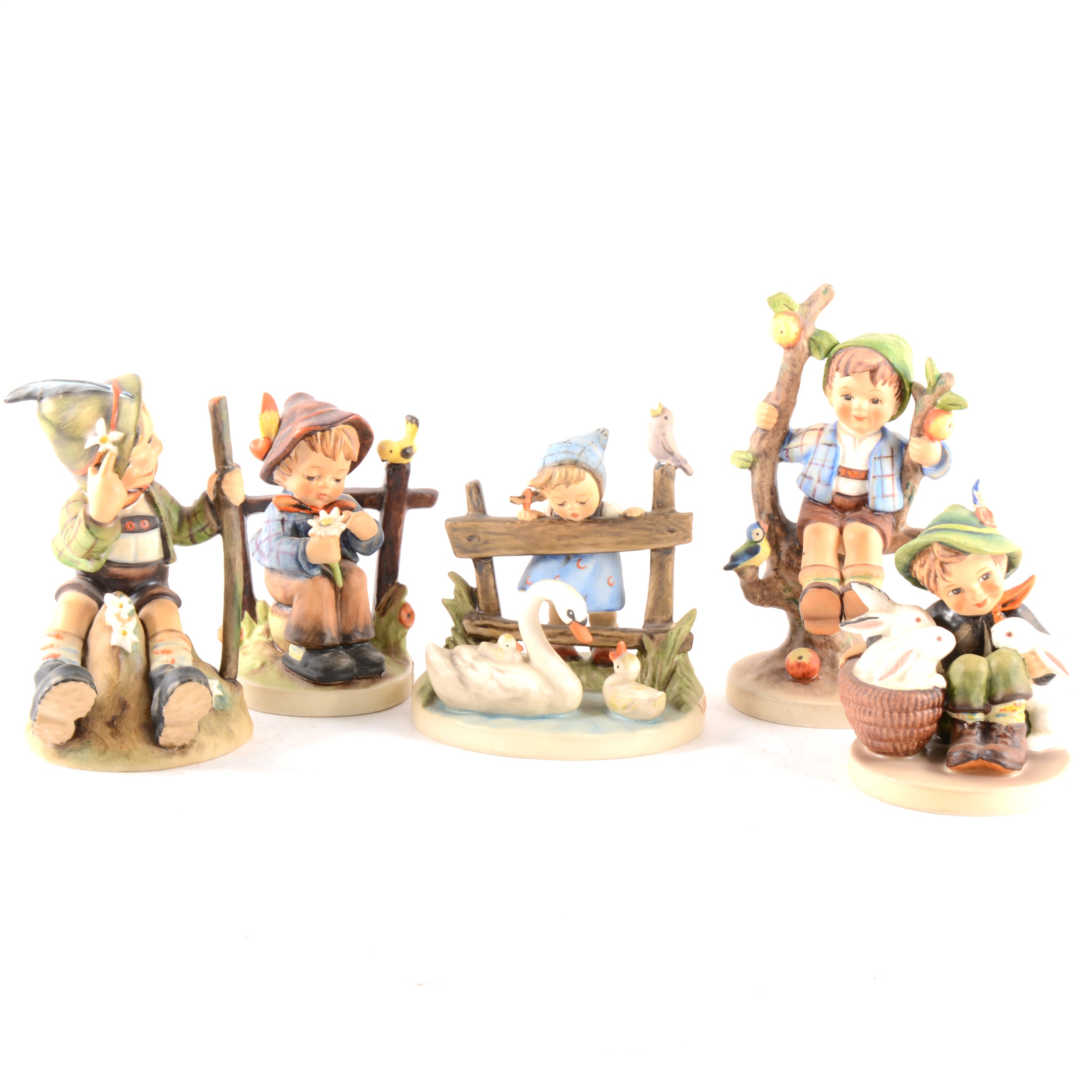 A collection of Hummel figurines, including Apple Tree, Boy and Girl, ...