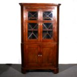 A George III mahogany free-standing corner cupboard