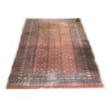 A Bokhara rug, trellis design on a red field, ...