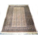 A Bokhara rug, fawn ground, trellis pattern field, ...
