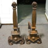 A pair of steel andirons, fluted uprights, scrolled feet, height 63cm.