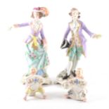 A pair of Sitzendorf figures, and a pair of figural menu stands