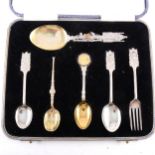 A set of silver commemorative spoons and other teaspoons.