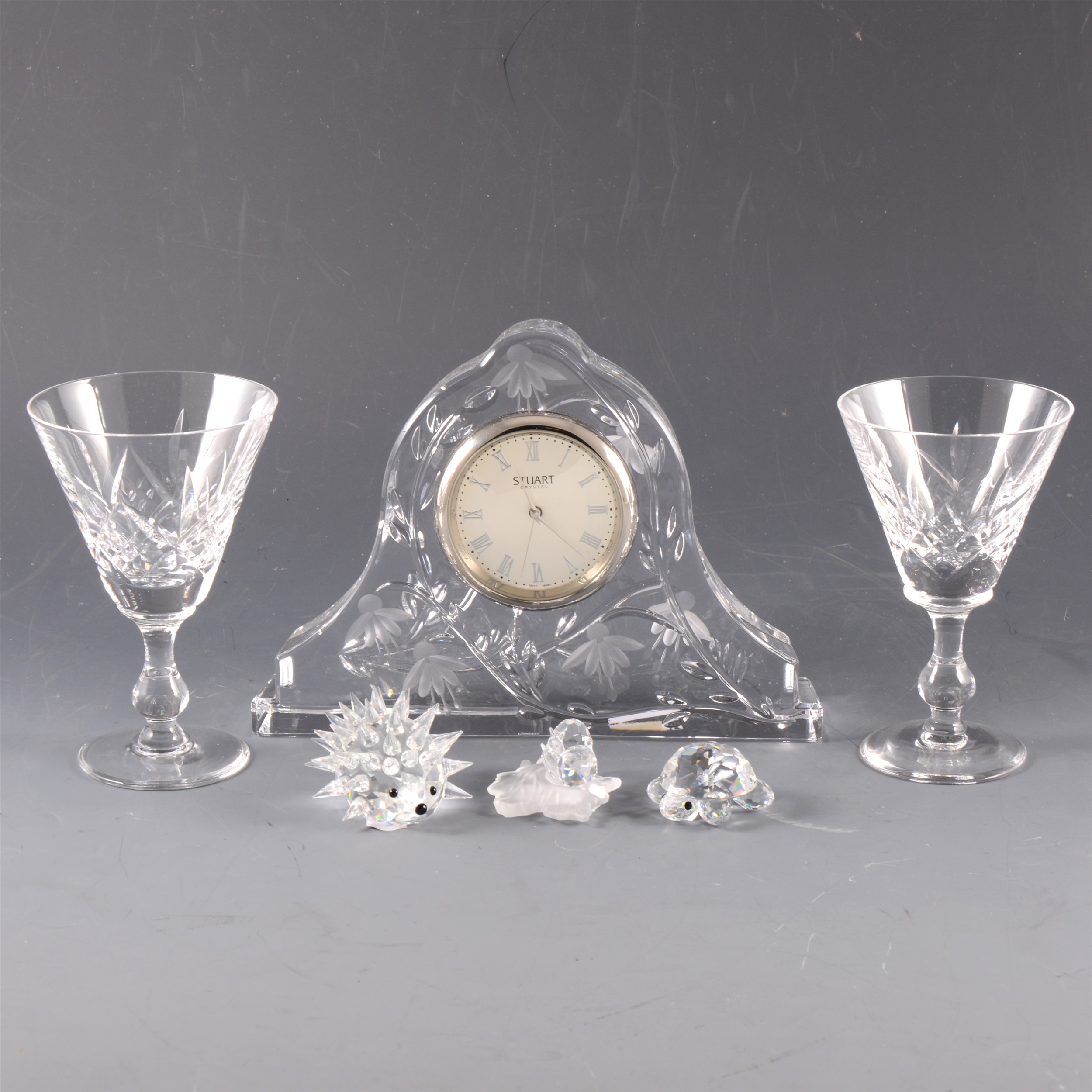 A collection of glassware, including Waterford Crystal clock, Stuart Crystal clock and Swarovski