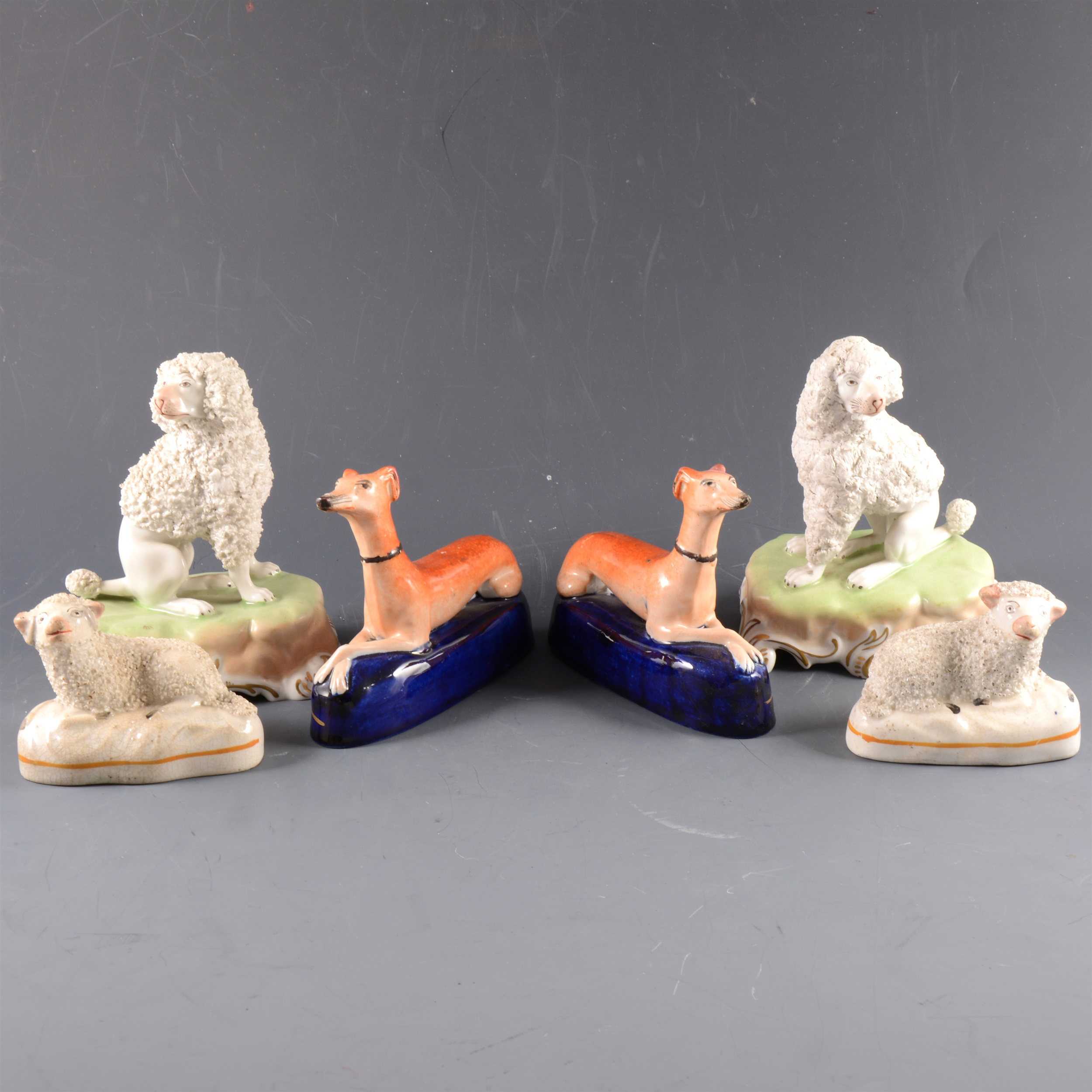 A pair of Dresden porcelain models of seated poodles, ...