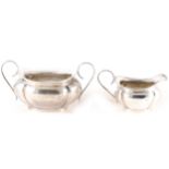 A silver milk jug and sugar bowl by Joseph Gloster Ltd, Birmingham 1921