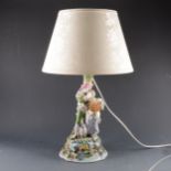 A Continental porcelain lamp base, modelled as a young couple, ...