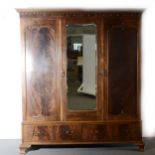 A stained wood triple wardrobe, ...
