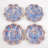 Four Imari shallow bowls, lotus leaf shape, decorated in blue and iron red.