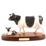 Royal Doulton, Friesian Cow and Calf, on wooden plinth