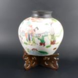 A Chinese polychrome vase on hardwood stand