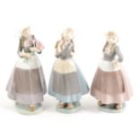 Three Lladro models Dutch Girls, one with tulips, ...