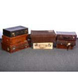 A collection of five various leather suitcases, ...