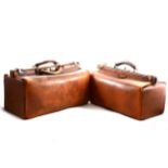 Two brown leather Gladstone bags.