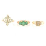 Three dress rings, an emerald three stone ring, amblygonite cluster ring, zultanite and diamond