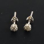 A pair of circular diamond cluster earrings.
