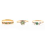 Three emerald and diamond rings.