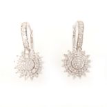 A pair of diamond cluster earrings.