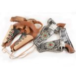Two pairs of Lone Star Wild West type revolvers in pouches; including the Super Cowboy, and the
