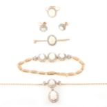A suite of opal jewellery - necklace, bracelet, brooch, earrings and ring.