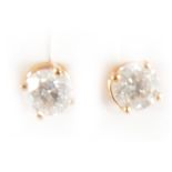 A pair of diamond solitaire earrings.