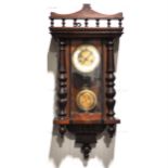 A small walnut and stained beechwood cased Vienna wall clock,