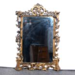 A Rococo inspired ebonised and parcel gilt pier glass, probably 19th Century, ...