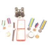 First and Second War medals, two pocket watches, two wrist watches, pair of binoculars, red Cartier