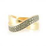 A green diamond 18 carat gold crossover ring.