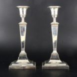 A pair of silver filled candlesticks