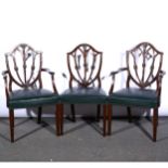 A set of eight Hepplewhite style mahogany and stained wood shield-back dining chairs, ...