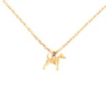 A yellow metal Fox Terrier pendant and chain