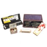 A box of miscellaneous items, including Hohner Germany Harmonica, drawing set, pair of silver