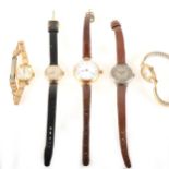 A lady's gold Omega watch, two other gold case watches, a Tissot gold-plated wrist watch.