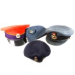 A Grenadier Guards cap, other caps and beret.