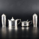 A pair of silver peppers, makers mark worn, London 1909, and two oval mustards.