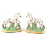A pair of Staffordshire pottery 'Zebra' models