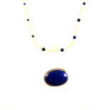 A lapis lazuli brooch and seed pearl necklace with lapis beads.