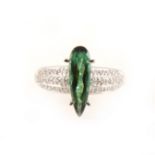 A green tourmaline and diamond dress ring.