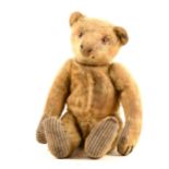 A Steiff mohair teddy bear, jointed limbs, glass eyes, hump back, with original Steiff button in