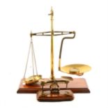 A set of brass balance scales, and a set of postal scales