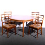 An extending teak dining table and four chairs, circa 1976