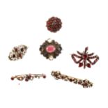 Six Victorian and later brooches set with almandine garnets and similar red stones.
