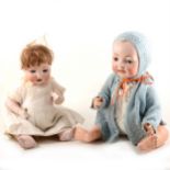 Two German bisque head baby boy dolls, one with 99/7 head stamp, both with fixed eyes and open